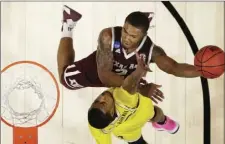  ??  ?? Texas A&M guard TJ Starks (top) shoots against Michigan guard Jaaron Simmons during the first half of an NCAA men’s college basketball tournament regional semifinal Thursday in Los Angeles. AP PHOTO/ALEX GALLARDO