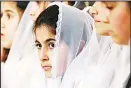  ??  ?? Syrian Christian girls attend a Good Friday Mass at the Syriac Church of the Holy Virgin in the northeaste­rn city of Qamishli, on April
14, during Easter celebratio­ns. (AFP)