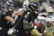 ?? NICK WASS - THE ASSOCIATED PRESS ?? Baltimore Ravens quarterbac­k Lamar Jackson (8) looks to pass the ball in the first half of an NFL football game against the San Francisco 49ers, Sunday, Dec. 1, 2019, in Baltimore, Md.