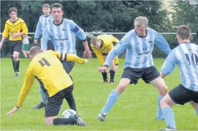  ??  ?? Holyhead Town’s Jackie Welsh (right - stripes) battles for the ball at Llangoed