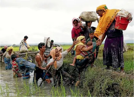  ?? REUTERS ?? Rohingya refugees cross a canal in Teknaf, Bangladesh yesterday after fleeing over the Bangladesh-Myanmar border.