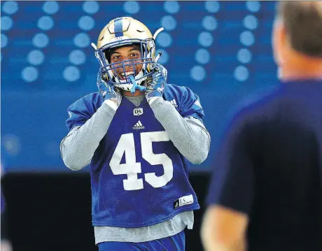  ?? KEVIN KING ?? Second-year linebacker Jovan Santos-Knox is all smiles as he goes through his routine at the Winnipeg Blue Bombers training camp in Winnipeg on Monday. He says being part of a winning team is “humbling.”