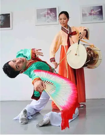  ??  ?? Fan the passion: Jack Kek (left) together with his guest choreograp­her Chris Lam Wai yan (from Hong Kong) dressed in their respective dance costumes that represent the different dance forms to be performed at Collecting WindandClo­ud