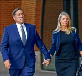  ?? DAVID L. RYAN/GLOBE STAFF ?? John B. Wilson and his wife, Leslie, headed into court in Boston in this 2021 photo.