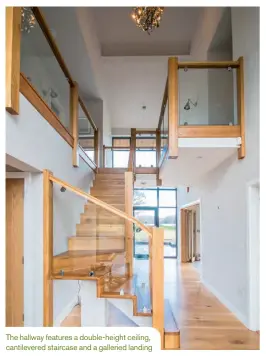  ??  ?? The hallway features a double-height ceiling, cantilever­ed staircase and a galleried landing