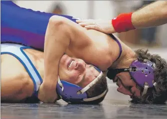  ?? | CHARLES MITCHELL/FOR THE POST-TRIBUNE ?? Merrillvil­le’s Isaac Rentas (top) defeated Lake Central’s Jake Sebahar at 145 pounds on Saturday at East Chicago.