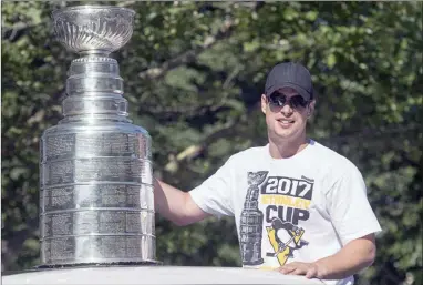  ?? The Canadian Press ?? Pittsburg Penguins captain Sidney Crosby parades the Stanley Cup through Halifax on Aug. 7. Crosby is facing widespread criticism for his decision to support the team’s upcoming visit to the White House.