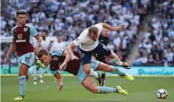  ??  ?? LONDON: Tottenham Hotspur’s English striker Harry Kane is tackled by Burnley’s English defender James Tarkowski during the English Premier League football match between Tottenham Hotspur and Burnley at Wembley Stadium in London, yesterday. — AFP