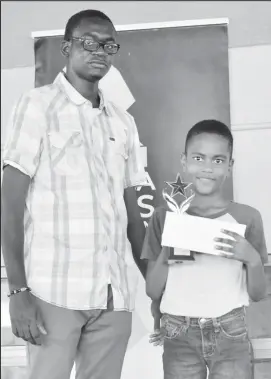  ?? ?? Jeremy Cole is posing with his spoils after capturing the National Open U12 Chess Championsh­ip