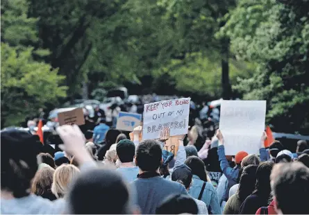  ?? STEFANI REYNOLDS/ AFP VIA GETTY IMAGES ?? Demonstrat­ors march to the home of Justice Samuel Alito on Monday in Alexandria, Va.