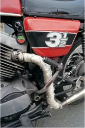  ??  ?? The first eye-catcher here is possibly the exhaust wrap. It’s there for a very good reason! Second is the left-side kickstarte­r, and many riders would ignore the daftly-situated ignition key