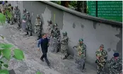  ?? — AFP ?? Army personnel stand guard along a street during an indefinite strike called by the Gorkha Janmukti Morcha in Darjeeling on Monday.