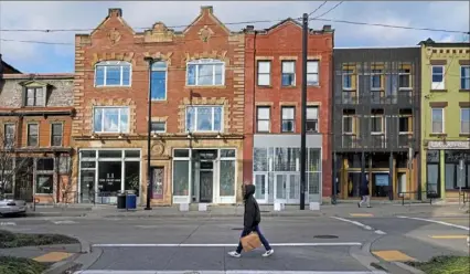  ?? Steve Mellon/Post-Gazette ?? Businesses along this stretch of Penn Avenue at Gross Street in Garfield have had to adapt to survive.