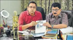  ?? RAVI CHOUDHARY/HT PHOTO ?? VC Misra (right) with his son Manas at his laboratory in Indirapura­m, Ghaziabad. He is one of India’s better known handwritin­g experts.