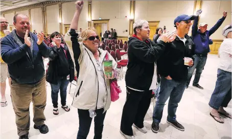  ?? DAN JANISSE ?? Caesars Windsor employees react after learning their contract was ratified by a vote of 75 per cent on Monday at the Ciociaro Club. The union says there have been improvemen­ts on job security.