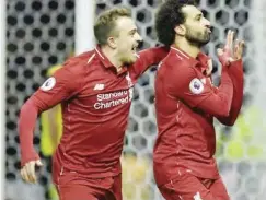  ??  ?? Mohamed Salah (right) scored the opening goal of Liverpool's 3-0 win at Watford.