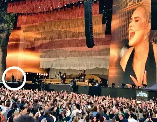  ?? ?? Spot the star: Adele, circled, is dwarfed by the stage set and big screen