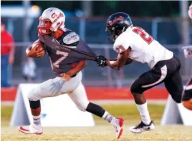  ?? STAFF PHOTO BY DOUG STRICKLAND ?? Ooltewah quarterbac­k Kyrell Sanford’s shoulder pad pops out of his jersey as he breaks a tackle by Maryville linebacker Tommy Smith during their game on Oct. 12 at Ooltewah High School. Sanford is this week’s Waffle House All-Star honoree.