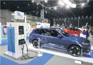  ?? WICHAN CHAROENKIA­TPAKUL ?? A demo of an electric vehicle charging station at the Fast Auto Show Thailand & EV Expo. EVs are not the only mobility choice that promotes cleaner energy.