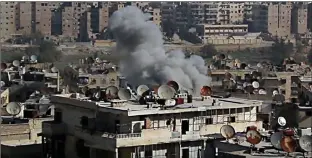  ?? Associated Press ?? This frame grab from video provided by the Aleppo News Network shows smoke rising following an air strike that hit insurgents’ positions on Friday in eastern neighborho­ods of Aleppo, Syria.