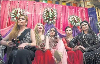  ??  ?? BANDED TOGETHER: A party for the Pakistani transgende­r community in Peshawar. Many make their living by conducting ceremonial rituals, but they are still often forced into begging or prostituti­on.