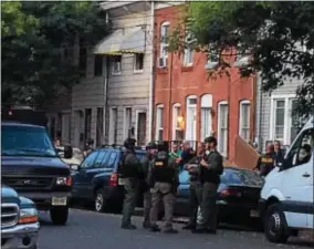  ?? L.A. PARKER - THE TRENTONIAN ?? New Jersey State Police raided a home in the 700 block of Division Street Thursday morning. Sources say the target of the raid was not in the home and no arrests were made.