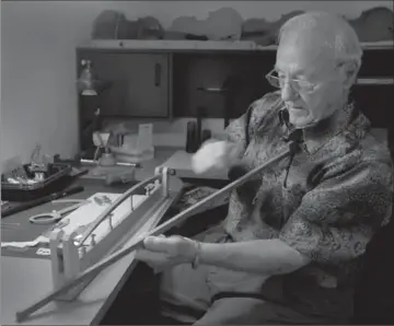  ??  ?? Above, Bill Marykuca in his Beamsville home working with the highly-regarded Brazilwood he uses for bows. Above right, a vice of sorts to shape the bow. To the left, the work area, and some of his precision instrument­s.