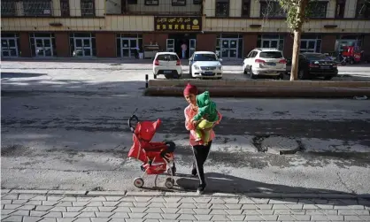 ?? Photograph: Héctor Retamal/AFP/Getty Images ?? A mother in Aksu in China’s Xinjiang region, where women are being threatened with internment for refusing to abort pregnancie­s that exceed birth quotas.