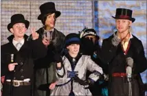  ?? HENRY HUEY / ROUND ROCK LEADER ?? Members of McNeil High’s choir sing Christmas carols Wednesday at Prete Plaza downtown. Carolers are Justin Stamps (from left), Cody Dosler, Haley Peeler and Drake Siegel.