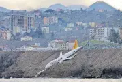  ?? [DHA DEPO PHOTOS VIA AP] ?? A Boeing 737-800 of Turkey’s Pegasus Airlines rests Sunday after skidding off the runway downhill towards the sea at the airport in Trabzon, Turkey. Trabzon Gov. Yucel Yavuz said all 162 passengers and crew on board were evacuated and safe early...