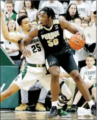  ?? MIKE MULHOLLAND | MLIVE.COM ?? Purdue forward Caleb Swanigan (50) works toward the basket against Michigan State forward Kenny Goins on Jan. 24, 2017.