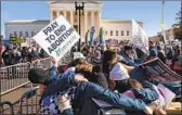  ?? Andrew Harnik Associated Press ?? ABORTION foes pray in front of the Supreme Court on Dec. 1 as justices weigh Mississipp­i’s law.