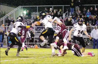  ?? RANDY MOLL NWA NEWSPAPERS ?? Prairie Grove senior quarterbac­k Ethan Guenther sheds tacklers with a stiff-arm and churning knees. He ran six times for 31 yards and a pair of touchdowns during Friday’s 33-14 win by the Tigers.