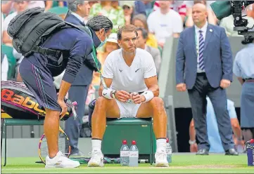  ?? AP ?? Rafael Nadal receives treatment during a medical timeout as he plays Taylor Fritz in the men's quarterfin­al at Wimbledon.