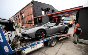  ?? ( AFP via Getty) ?? One of Andrew Tate’s many luxury cars is loaded onto a flat bed and taken away