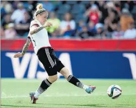  ?? Dennis Grombkowsk­i ?? ANJA MITTAG of Germany scores the sixth goal against Ivory Coast in an opening 10-0 victory. Mittag and Celia Sasic had three goals each in that game.