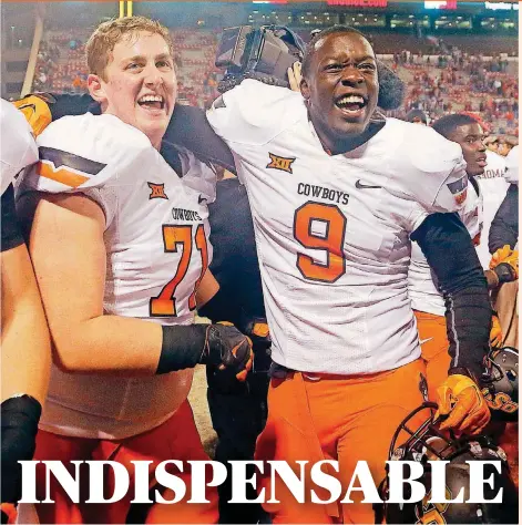  ?? [PHOTO BY CHRIS LANDSBERGE­R, THE OKLAHOMAN] ?? Oklahoma State’s Brad Lundblade, left, celebrates with Gyasi Akem after the Cowboys’ win over Oklahoma in 2014. Lundblade was a part-time starter that year after walking on, and earned a scholarshi­p the next season.