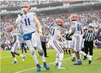  ?? STREETER LECKA/GETTY ?? UF quarterbac­k Kyle Trask (11) reacts after the game-clinching touchdown against South Carolina at Williams-Brice Stadium on Saturday.