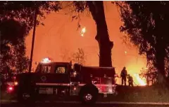 ?? — Reuters ?? Deadly blaze: Firefighte­rs working at the site of the wildfire in Goleta, California, US.