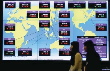  ?? — Reuters ?? A panel displays global stock indexes at the Hong Kong Exchanges in Hong Kong, China.
