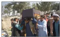  ?? (AP) ?? At a funeral Wednesday in Jalalabad, Afghanista­n, relatives carry the casket of a woman killed Tuesday in attacks claimed by the Islamic State.