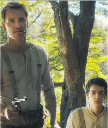  ?? SODA PICTURES ?? Michael Fassbender as Silas Selleck, left, Kodi Smit-McPhee as Jay Cavendish in Slow West.