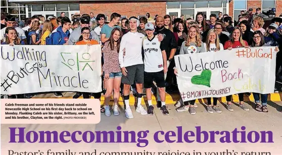  ?? [PHOTO PROVIDED] ?? Caleb Freeman and some of his friends stand outside Newcastle High School on his first day back to school on Monday. Flanking Caleb are his sister, Brittany, on the left, and his brother, Clayton, on the right.