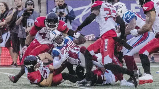  ?? DAVE SIDAWAY ?? Montreal Alouettes returner Stefan Logan was brought down by a host of Calgary Stampeders tacklers during Friday’s game in Montreal, which the Alouettes won 30-23.