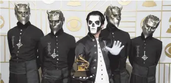  ?? CITIZEN NEWS SERVICE PHOTO ?? Ghost poses with the Grammy for best metal performanc­e at the 2016 Grammy Awards. Ghost is up for best rock album and best rock song at the Grammys this Sunday.