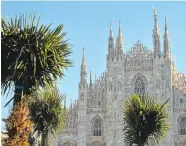  ?? GIUSEPPE CACACE/AGENCE FRANCE-PRESSE VIA GETTY IMAGES ?? Newly planted palm trees stand in front of Italy's Milan Cathedral at the Piazza del Duomo in Milan.