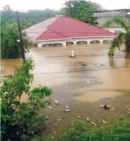  ?? CONTROBUTE­D PHOTOS ?? Almost covered by the floodwater­s is the home and property of Henry Blair, and his son, Dwayne. The men were trapped for two hours in the ceiling of the home, located in Palmetto Pen, Clarendon, on Saturday.