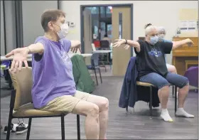  ?? BEN HASTY — READING EAGLE ?? Eva Beears, left, and Elaine Hartman participat­e in a senior exercise class held at Berks Encore, a senior services organizati­on in Reading.