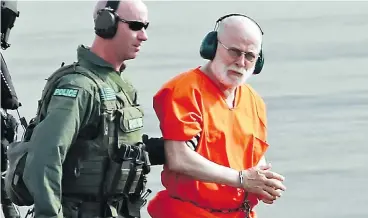  ?? STUART CAHILL / THE BOSTON HERALD VIA AP FILES ?? James “Whitey” Bulger is escorted from a U.S. Coast Guard helicopter after attending hearings in Boston federal court in 2011. Bulger, a notorious Boston gang leader, was found beaten to death in a West Virginia prison.