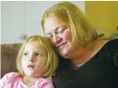  ?? AP PHOTO/RICK BOWMER ?? Bridgett Snelten sits with her daughter, Bella, at their home in Sandy, Utah.